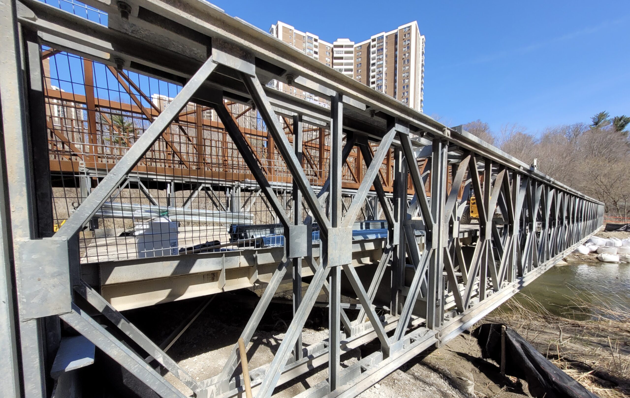 Close angled view of Bailey-Bridge-style construction access bridge
