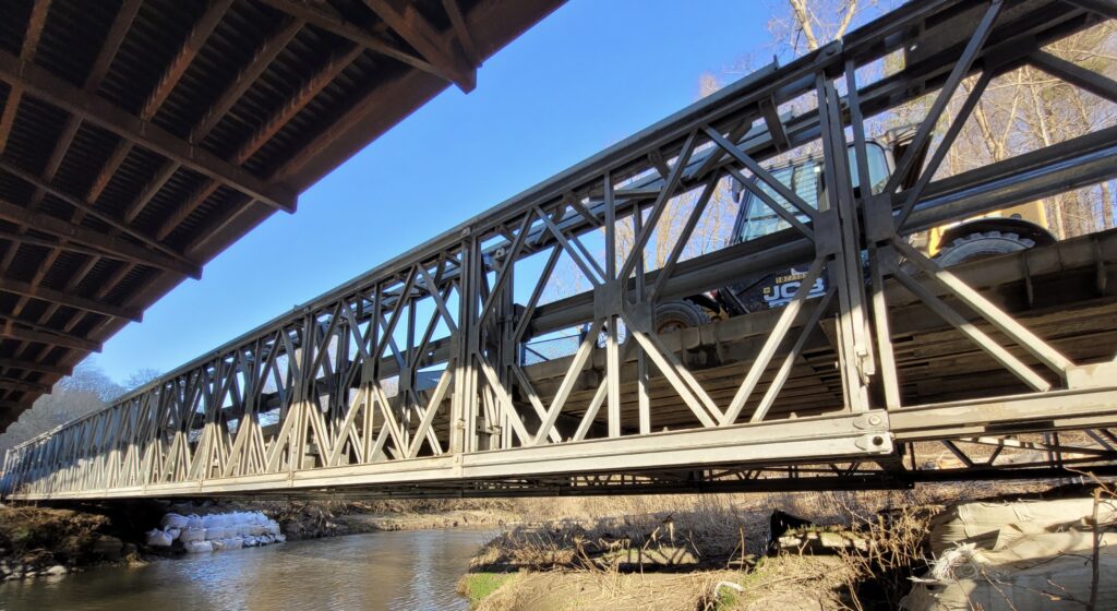 Low angled view of Bailey-Bridge-style construction access bridge